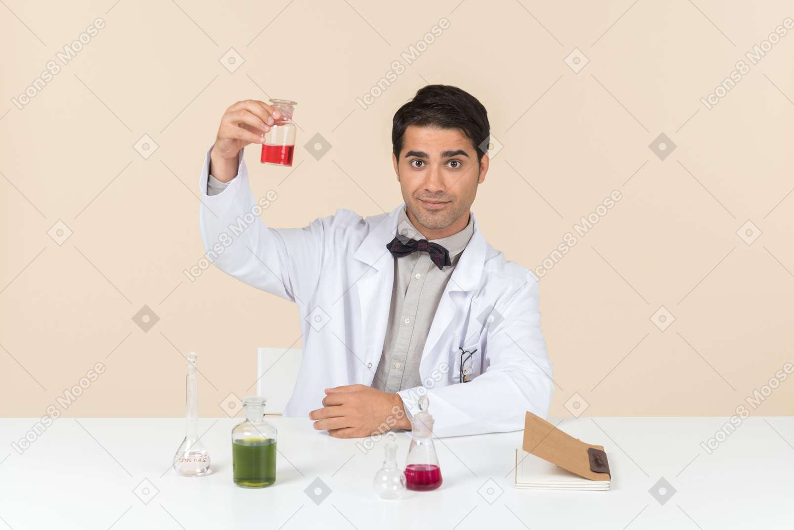 Worried male scientist sitting at the table and looking at bulb