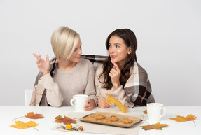 Young women drinking coffee and chatting