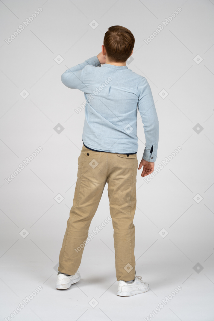 Back view of a boy calling someone