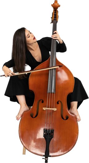 Front view of a young lady sitting on a chair while putting legs on double-bass