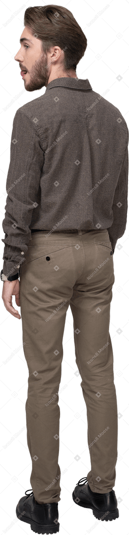 Three-quarter back of a young man in office clothing licking lips