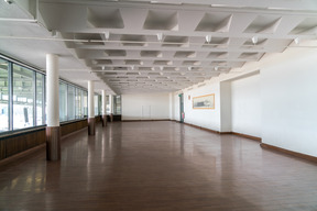 Spacious hallway with large windows and textured ceiling