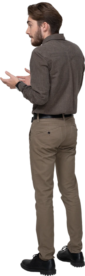 Three-quarter back view of a curious young man in office clothing