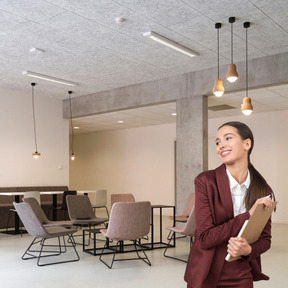 A business woman in a suit standing in an office