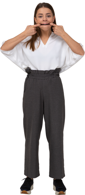 Front view of a grimacing young lady in office clothing