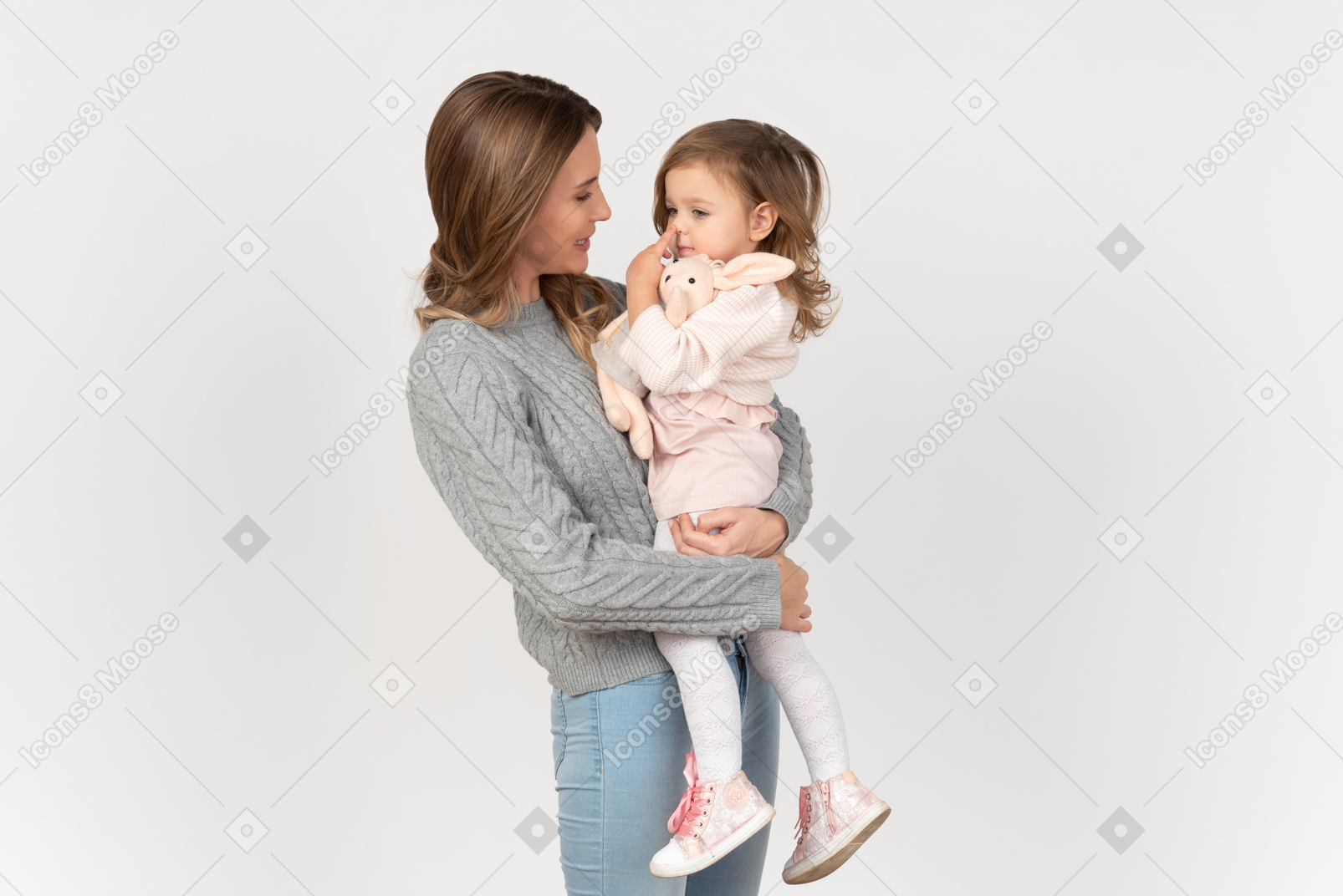 Young mom holding and hugging her little daughter