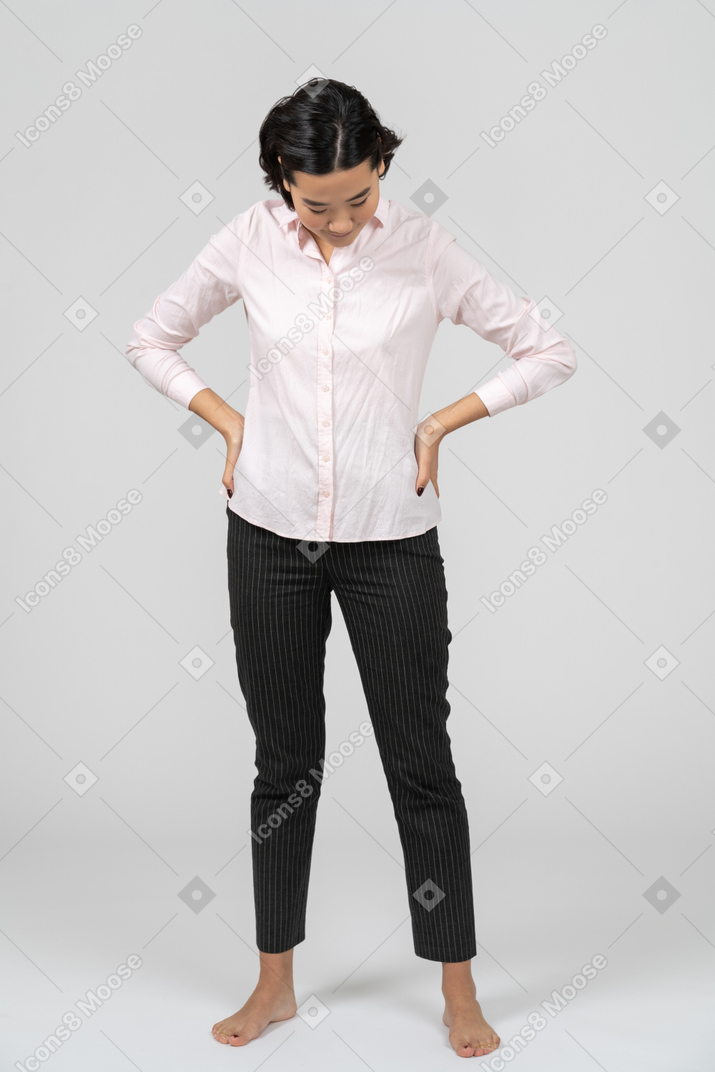 Woman in work clothes posing with hands on waist