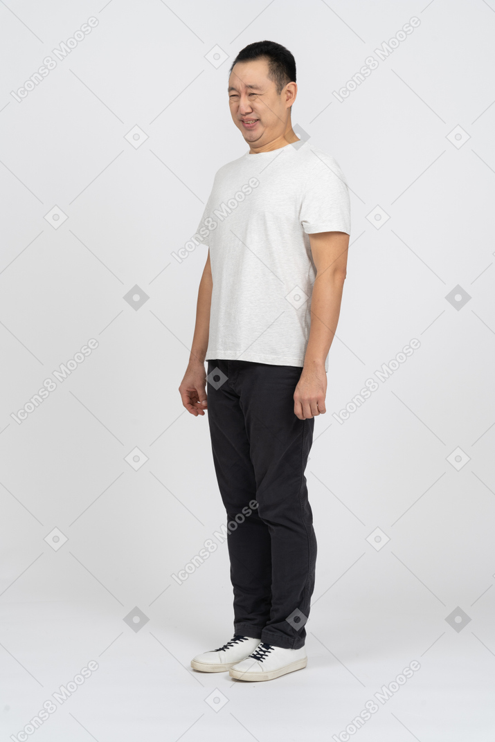 Front view of a man in casual clothes looking at something he doesn't like
