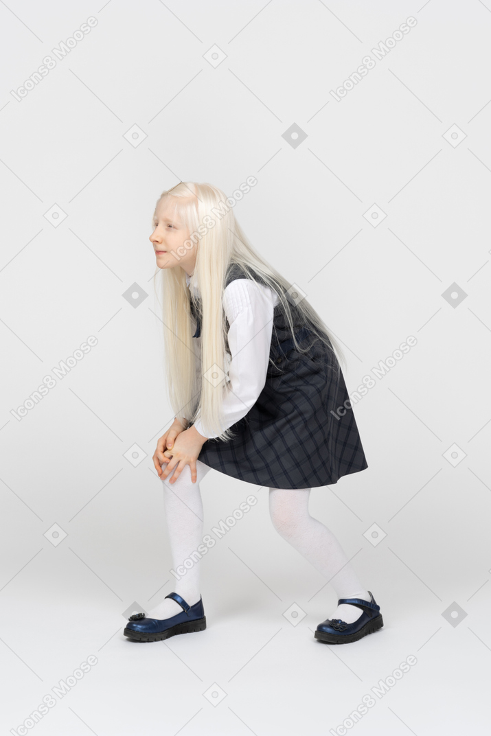 Side view of a schoolgirl with a hurt knee