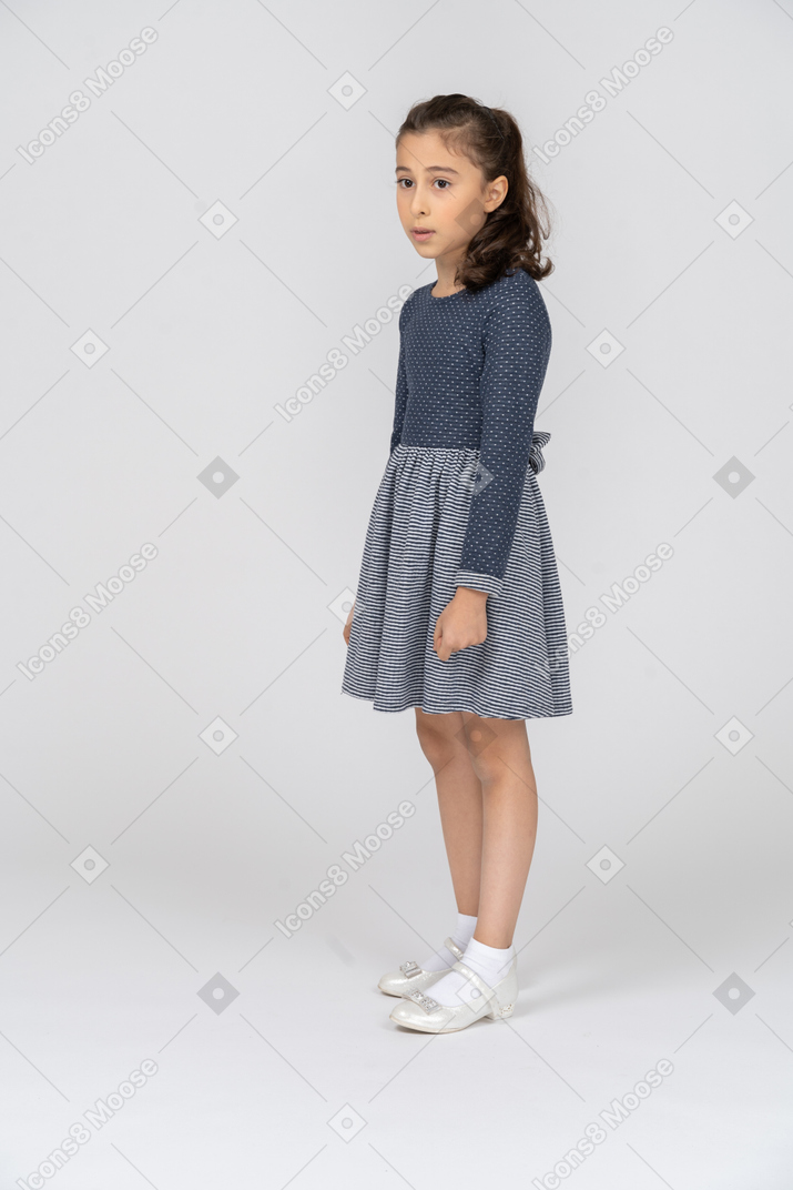 Three-quarter view of a girl looking to the side absent-mindedly