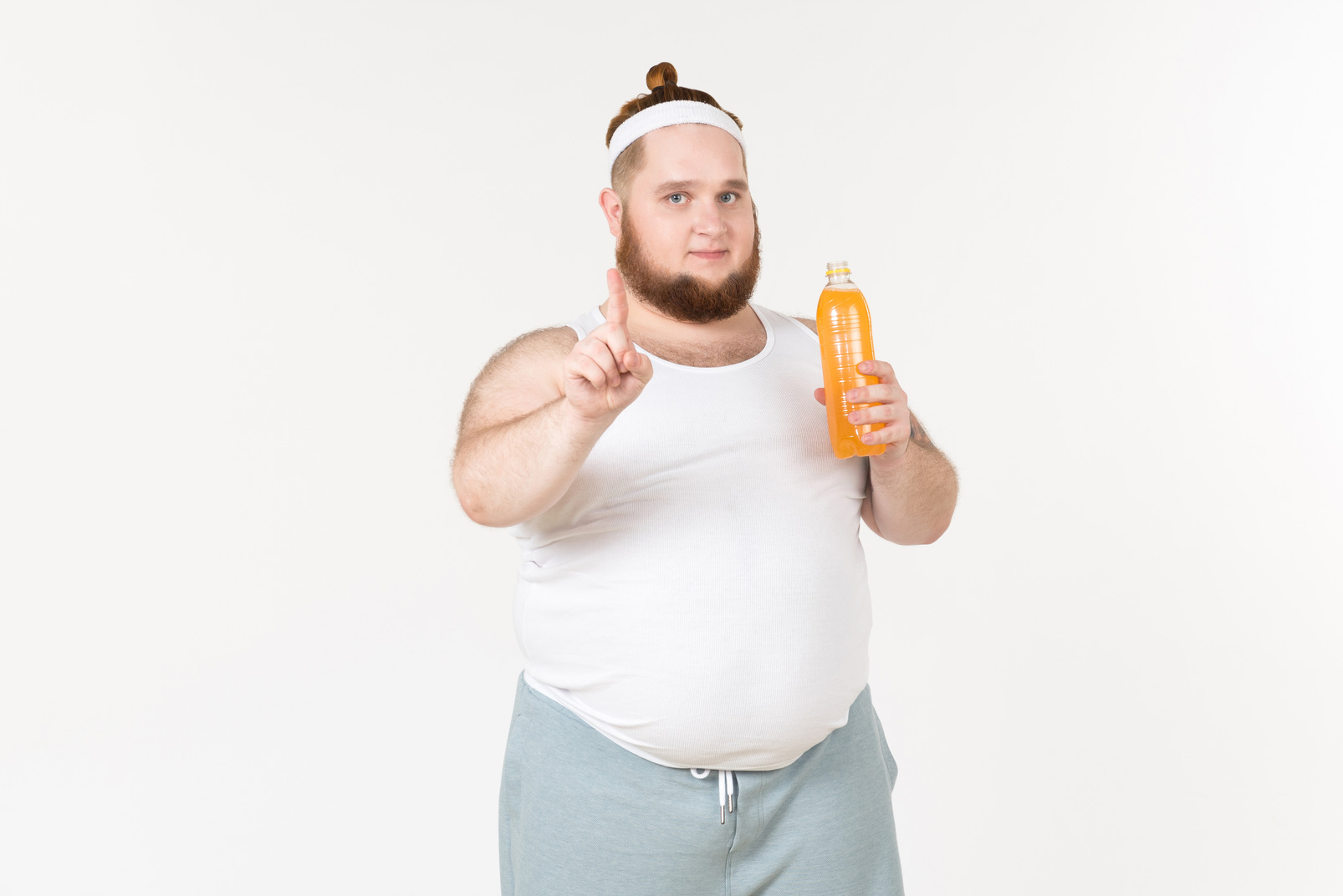 A fat sportsman with bottle of juice pointing index finger in the air