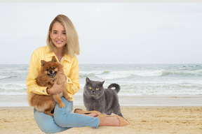 Woman and her pets spending time at the beach