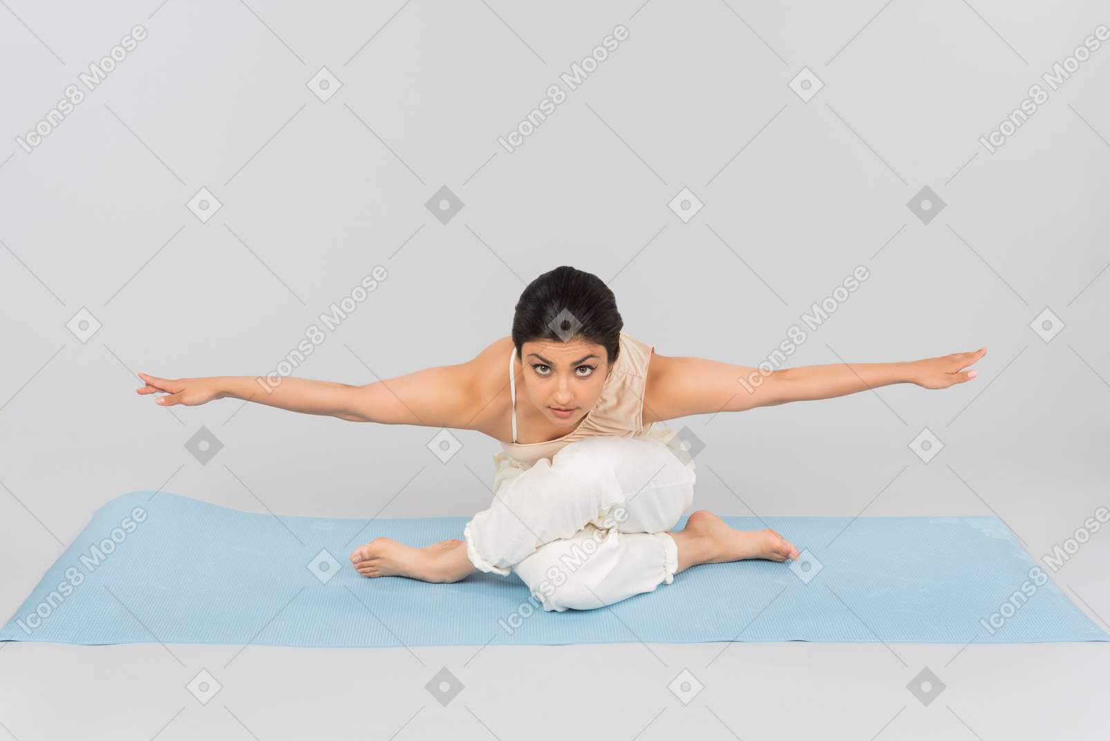 Young indian woman sitting in pose on yoga mat