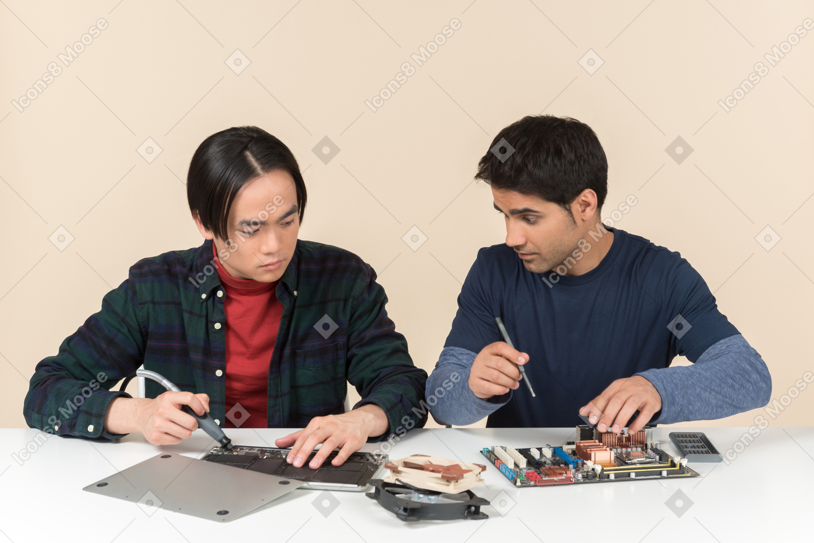 Two geeks sitting at the table and fixing some details