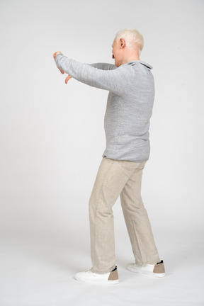 Side view of man giving thumbs down with two hands