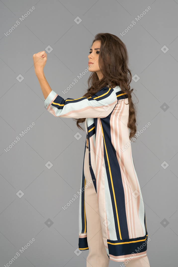 Young woman shaking a fist