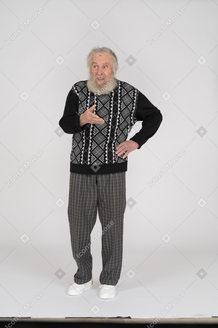 Front view of an old man gesturing questioningly