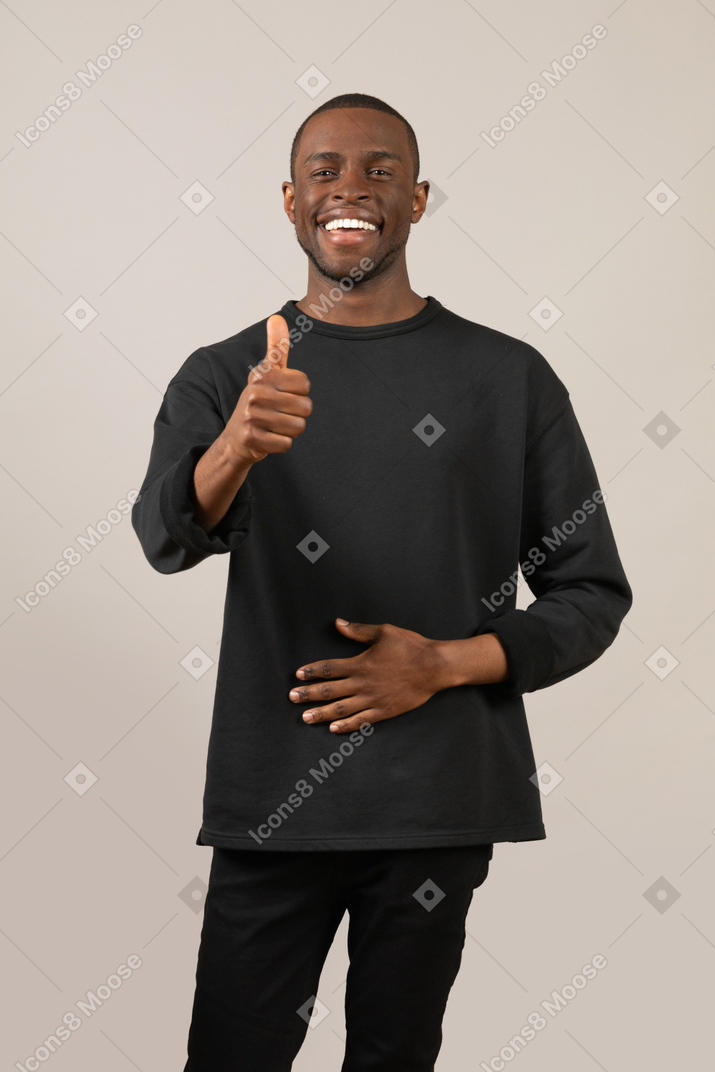Young man showing thumb up
