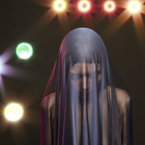 A woman with a veil on her head standing in front of a stage