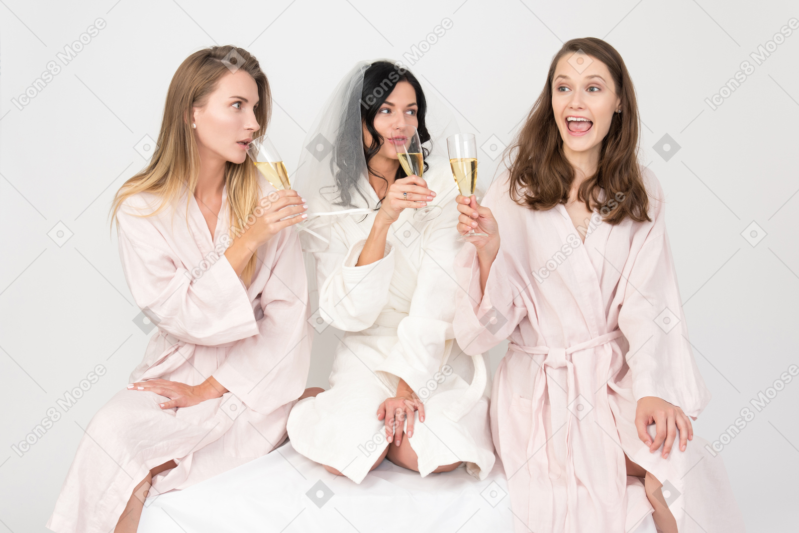 Bride and bridesmaids celebrating hen party and drinking champagne