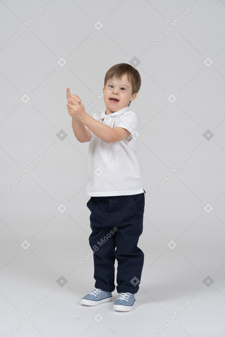 Front view of a boy pointing up