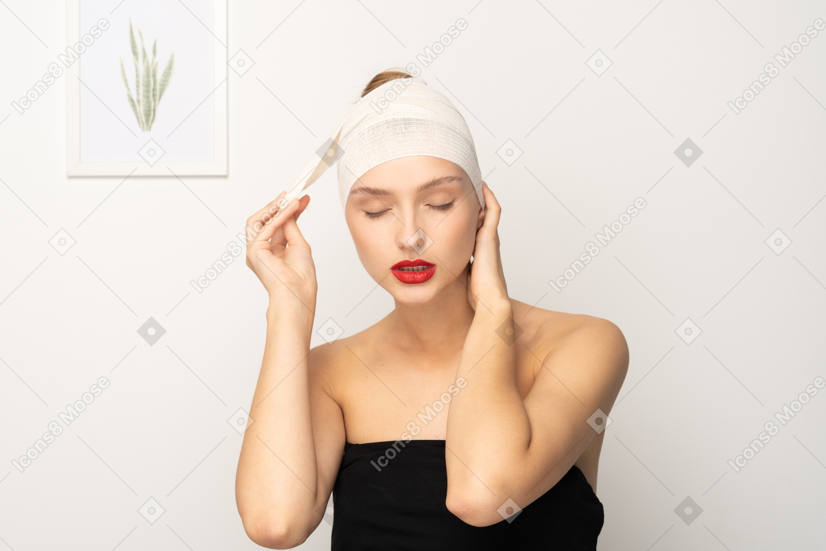 Female patient unwrapping her bandaged head