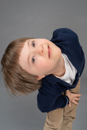 Cheerful little boy looking upwards