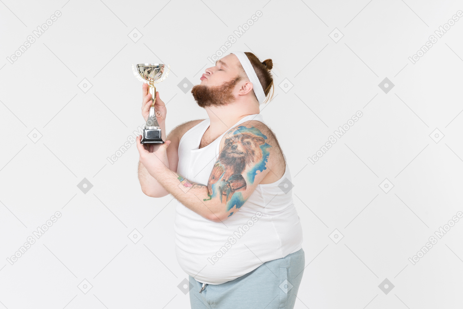 Big guy in sportswear kissing a trophy