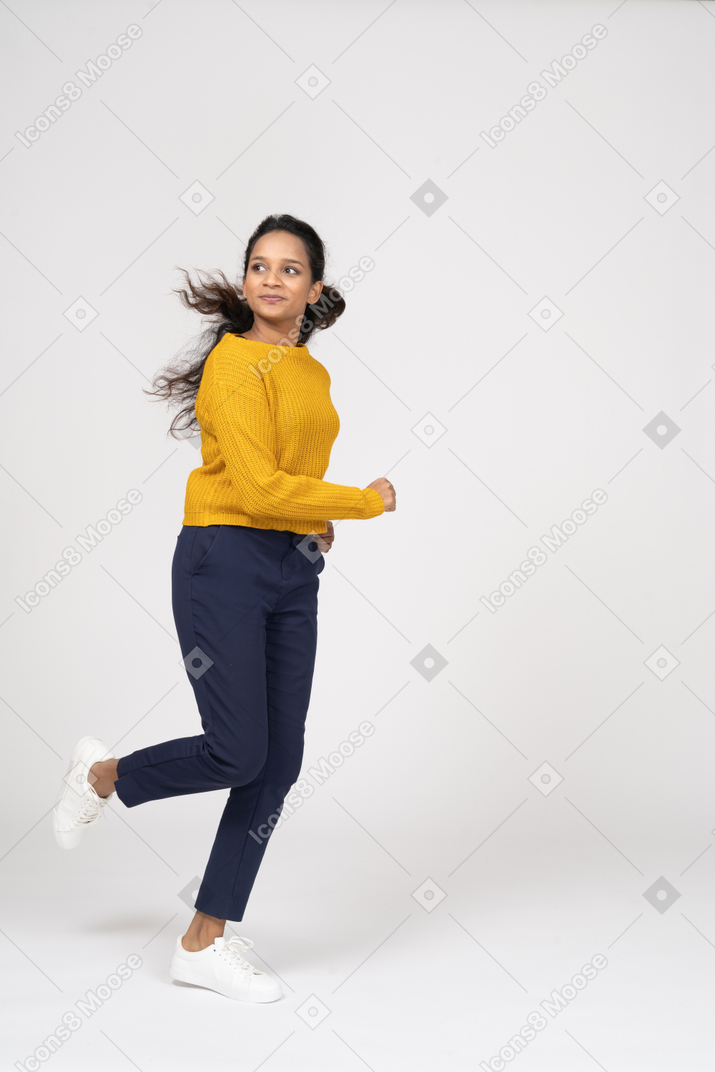 Side view of a girl in casual clothes running