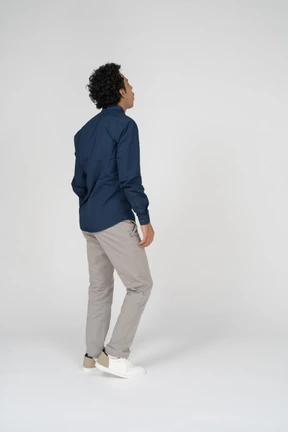 Man in casual clothes standing in profile