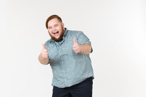 Young overweight man showing thumbs up with both hands