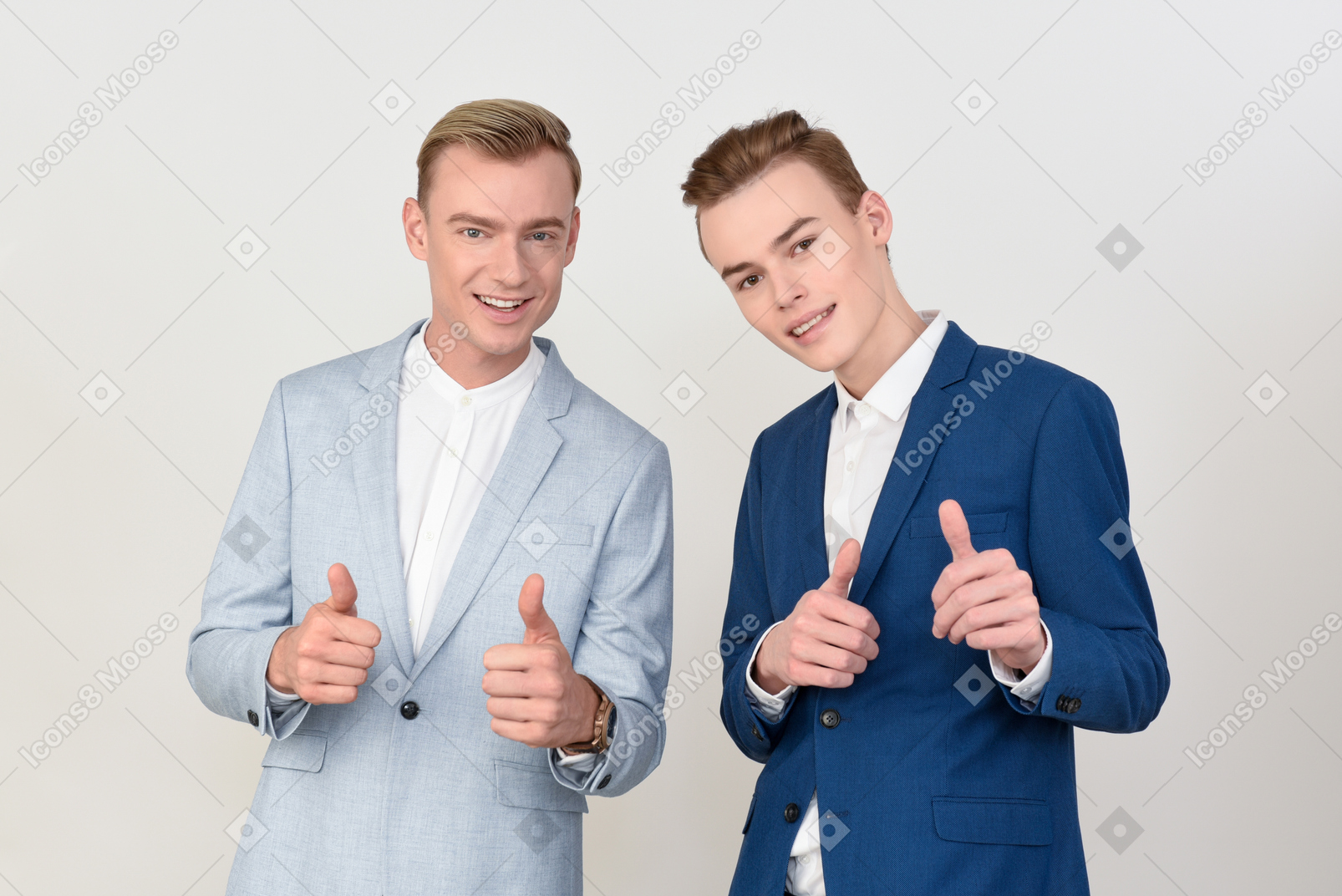 Handsome colleagues showing thumbs up