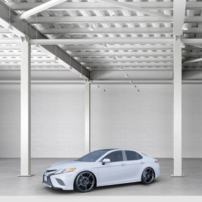 A white car is parked in a garage