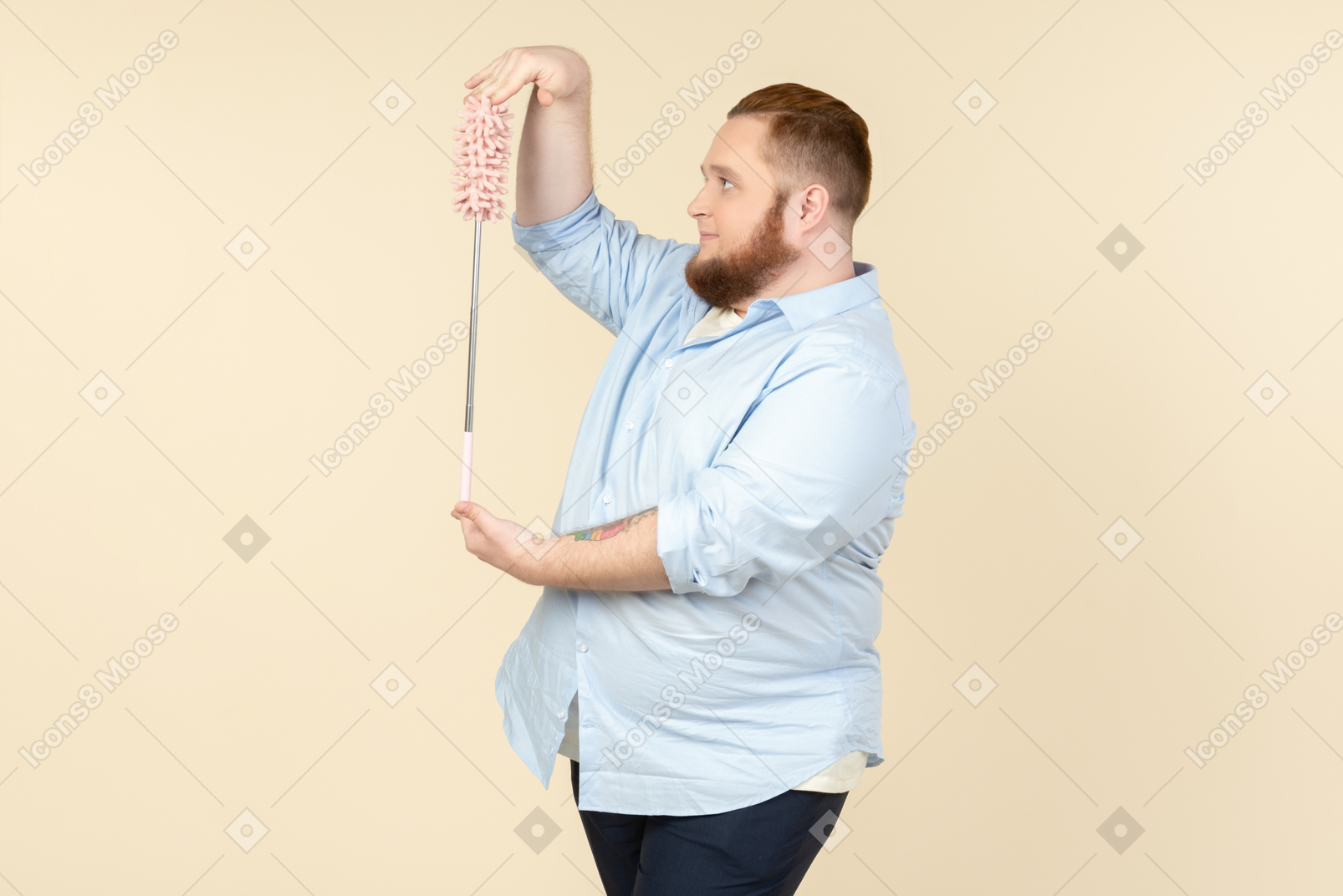 Young overweight househusband holding pipe-cleaner