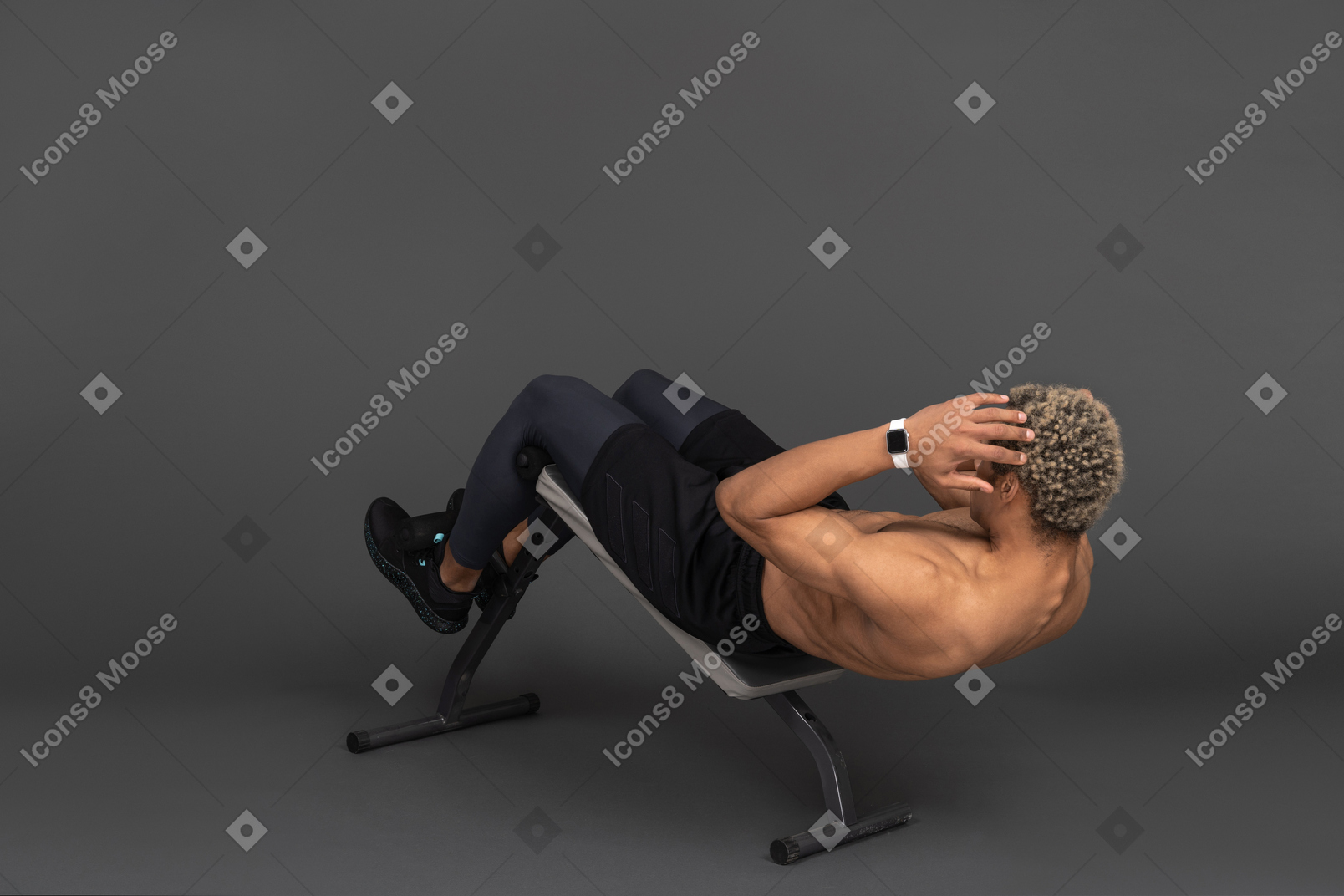 Three-quarter back view of a shirtless afro man doing crunches