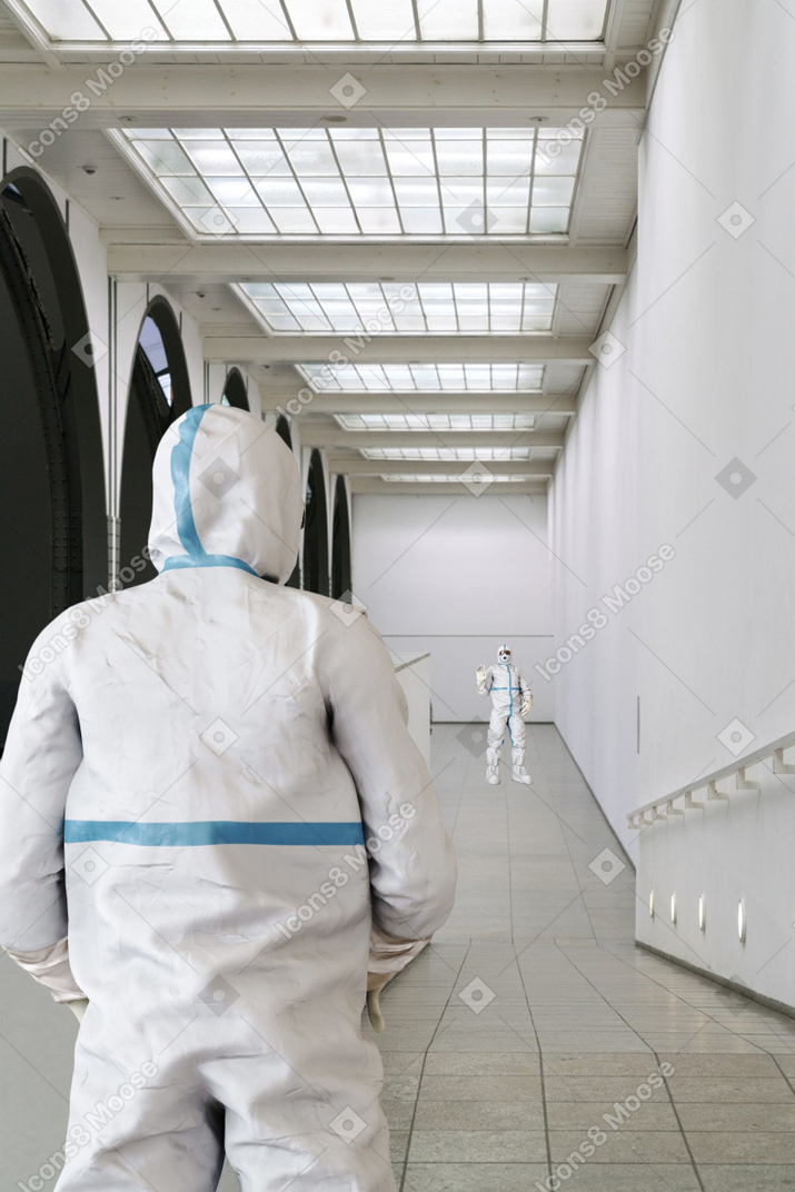 A pair of people in protective suits