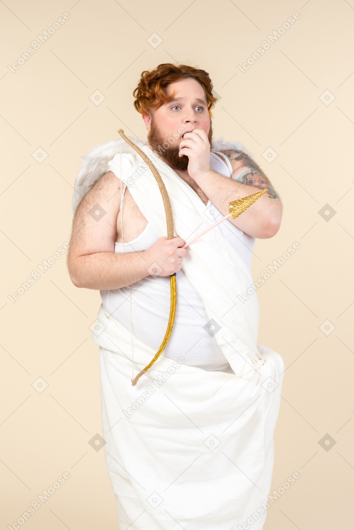 Gasping big guy wrapped in towel holding bow