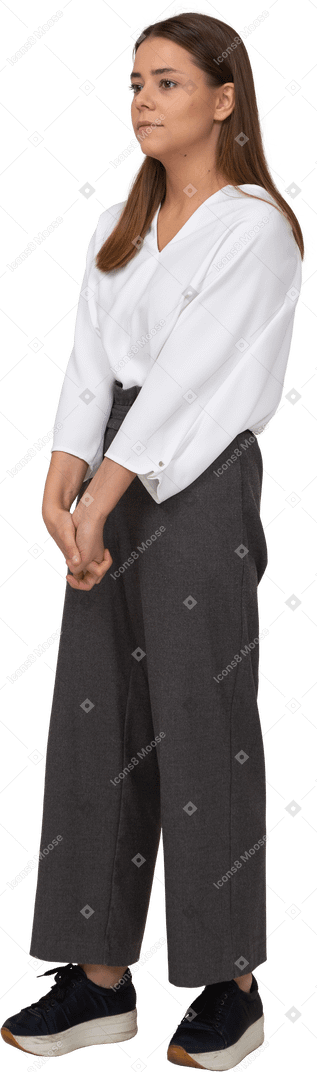 Three-quarter view of a young lady in office clothing holding hands together