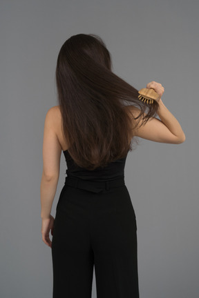 Woman combing her hair