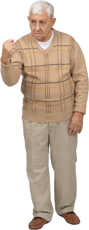Вид спереди на старика в повседневной одежде, показывающего кулак