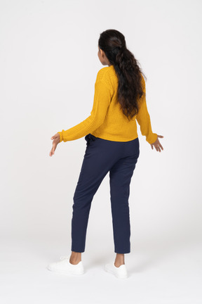Rear view of an emotional girl in casual clothes