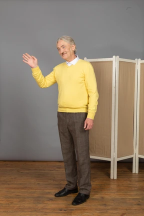 Three-quarter view of a friendly old man greeting