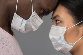 A young couple wearing face masks