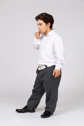 Thoughtful young man sticking out his bottom lip