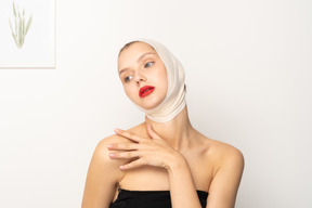 Woman with bandaged head touching shoulder