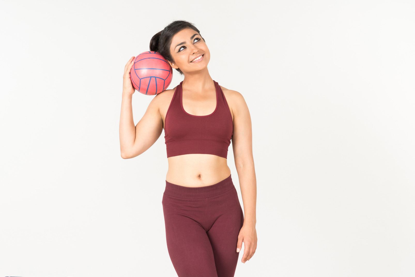 Young indian woman in sportswear drinking water