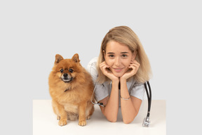 A veterinarian next to a dog