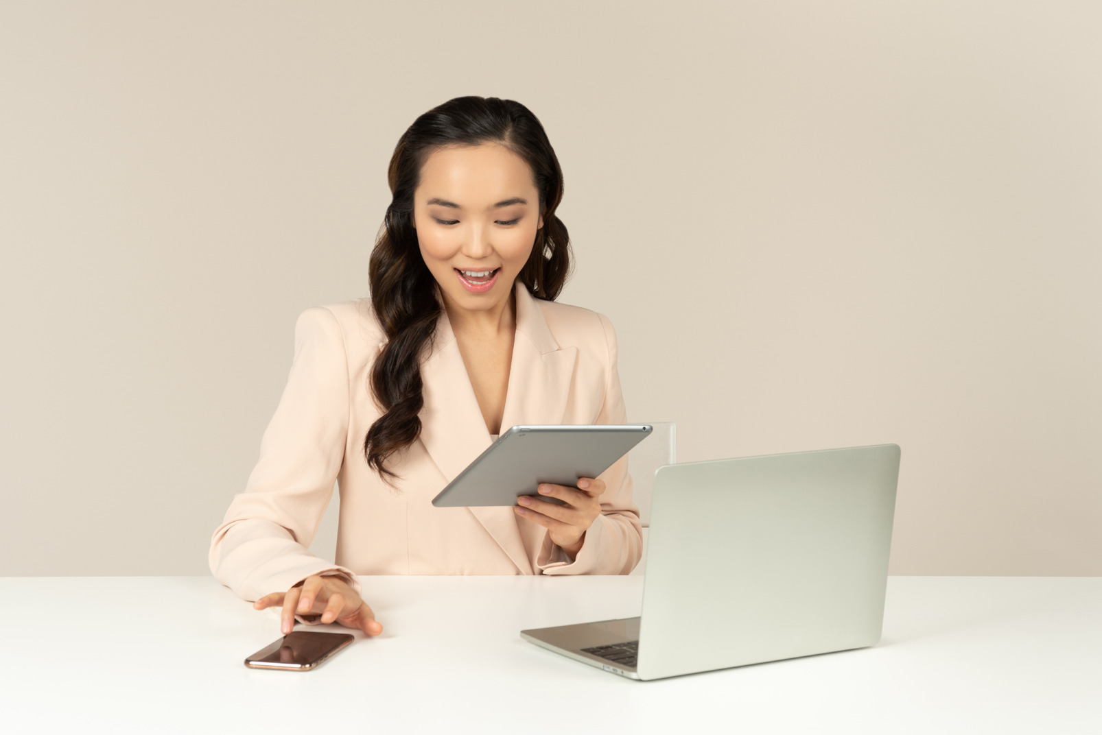 Smiling asian office employee using tablet