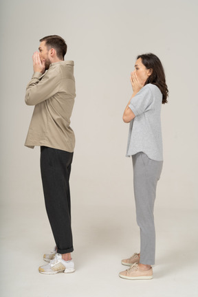 Side view of surprised young couple