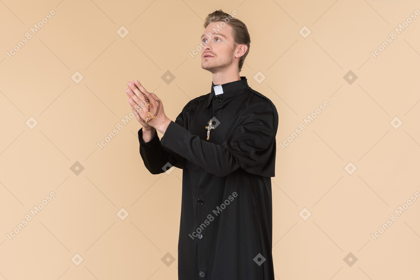 Catholic priest praying using prayer beads